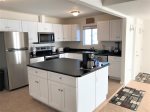 The kitchen is updated with high-end appliances and modern amenities